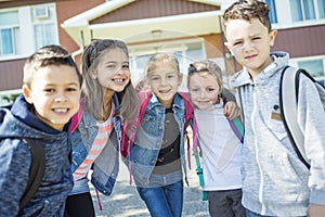 Students outside school standing together