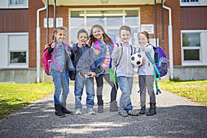 Students outside school standing together