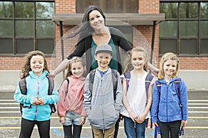 A Group of students outside at school standing together with teacher