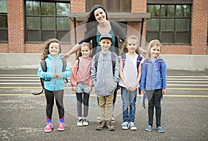 A Group of students outside at school standing together with teacher