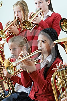 Group Of Students Playing In School Orchestra Together