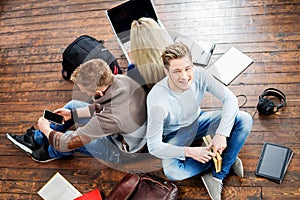 Group of students reading books, writing in notebooks