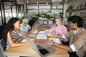 Group of students researching, studying together met in library