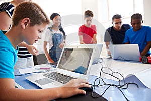 Group Of Students In After School Computer Coding Class Learning To Program Robot Vehicle
