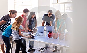 Group Of Students In After School Computer Coding Class Learning To Program Robot Vehicle