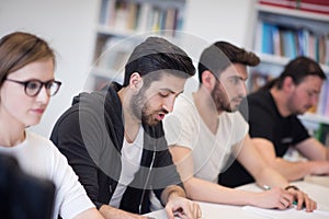 Group of students study together in classroom