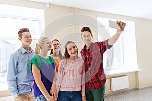 Group of students taking selfie with smartphone