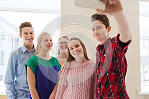 Group of students taking selfie with smartphone