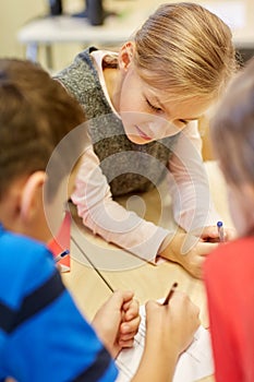 Group of students talking and writing at school