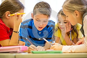 Group of students talking and writing at school