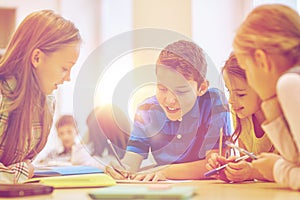 Group of students talking and writing at school