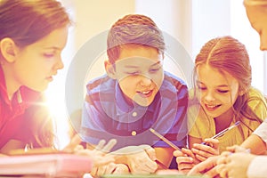 Group of students talking and writing at school