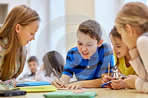 Group of students talking and writing at school