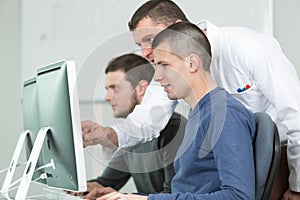 Group students with teacher in computer lab classrom