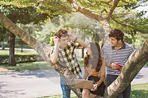 Group of students or teenagers with laptop and tablet computers hanging out.