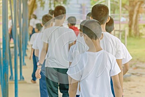 Group of students try to meditate for the peace of mind by walk with Buddhist monk