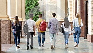 Group of students walking in college campus after classes