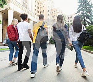 Group of students walking together in campus after studies