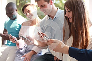 Group of students watching smartphones. Young people addiction to new technology trends.