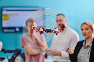 A group of students working together in a laboratory, dedicated to exploring the aerodynamic capabilities of a drone