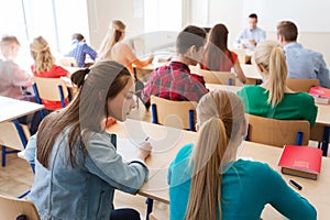 Group of students writing school test