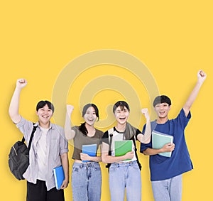 Group of stylish teenager students on yellow background