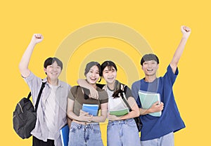 Group of stylish teenager students on yellow background