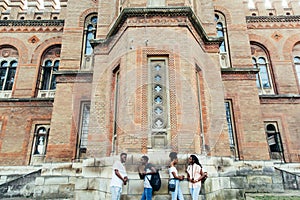 Group of stylish young african university students on campus. Multiracial young people standing together against wall in college