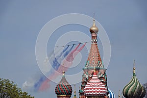 A group of Su-25 `Grach` attack aircraft smoke the colors of the Russian flag in the sky over Red Square during the dress rehearsa