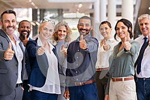 Group of successful business people showing thumbs up