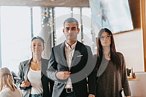 Group of successful business people standing together at office.