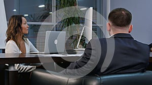 Group of successful business people talking together while working around a table in an office boardroom