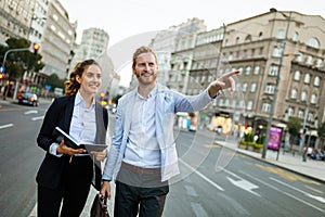 Group of successful business people working, walking in a city street.