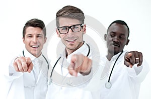 Group of successful doctors pointing to you.