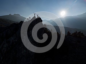 Group of successful mountaineers on the peaks of imposing mountains