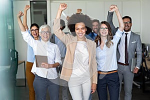 Group of successful multiethnic business people celebrating a good job in the office