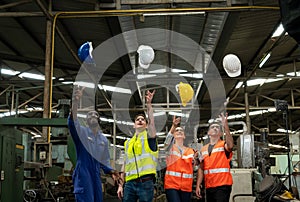 Group of Successful multiethnic engineer and technician worker throwing a hard hat in the Industry manufacturing factory