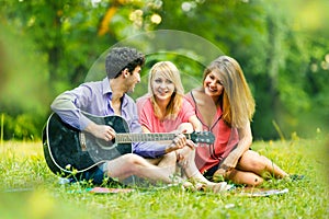 Group of successful students with a guitar resting