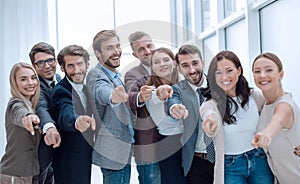 Group of successful young people pointing at you