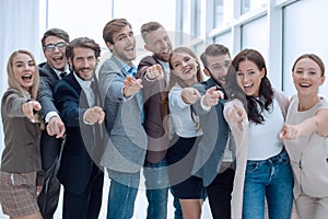 group of successful young people pointing at you