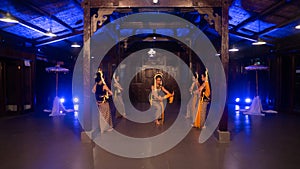 a group of sundanese dancers with jasmine and yellow shawls dance on stage