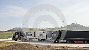 Group of supplies Tir camion on motorway parking,shipment goods transportation photo