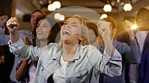 Group of supporters rising hands, championship excitement, sport event, fun