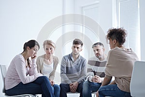 Group supporting sad woman