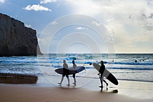 Group surfers surfboards beach Portugal