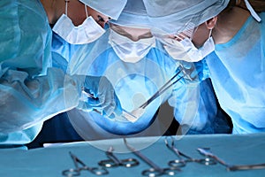 Group of surgeons in masks performing operation. Medicine, surgery and emergency help concepts