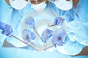 A group of surgeons is operating at the hospital, close-up of hands. Health care concept