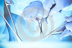 A group of surgeons is operating at the hospital, close-up of hands. Health care concept