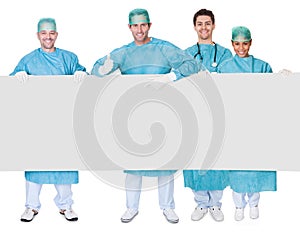 Group of surgeons presenting empty banner