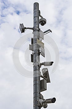 A group of surveillance cameras on a gray sky